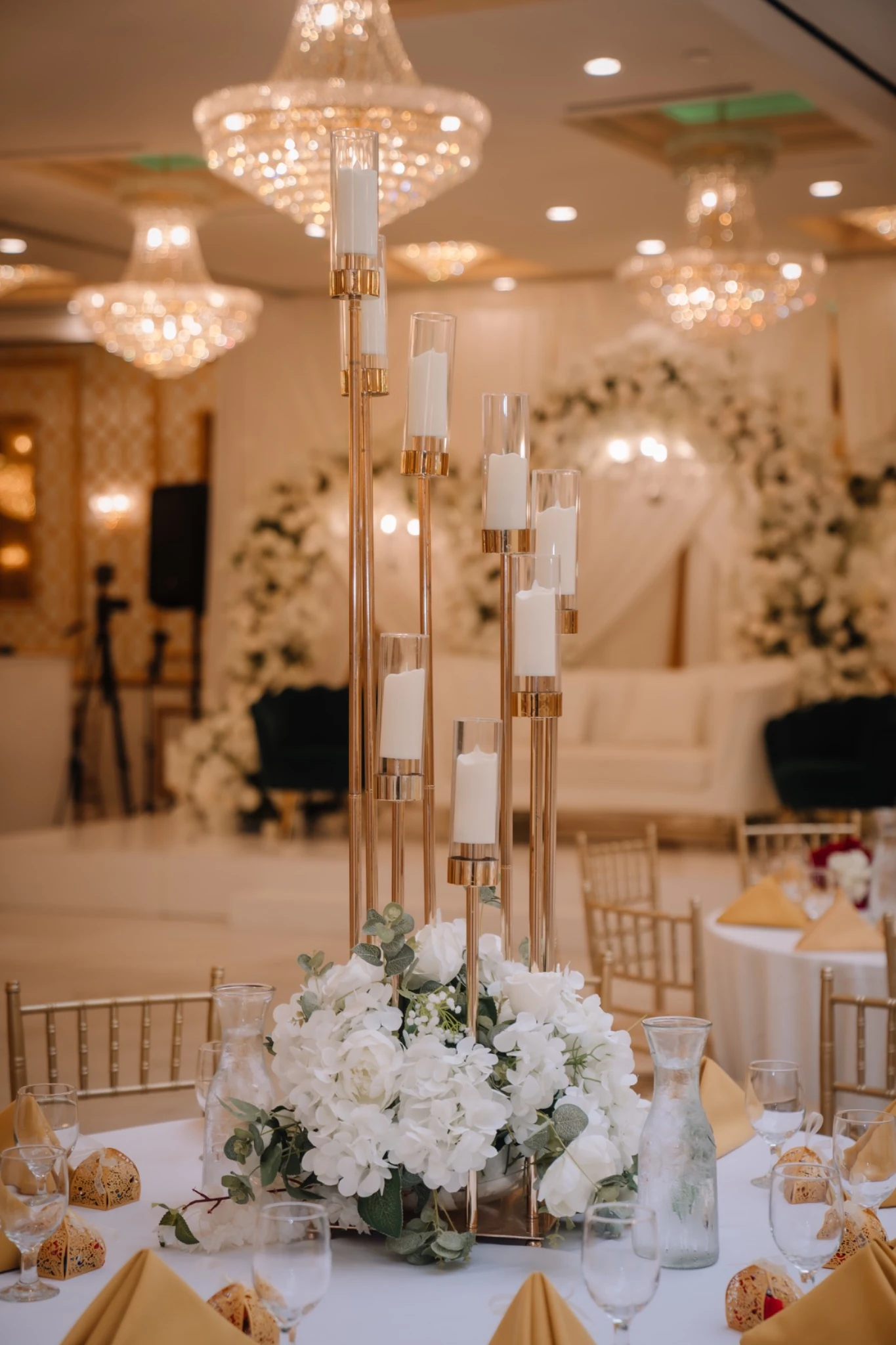 Ivory flowers and candle centerpiece at a Pearl wedding